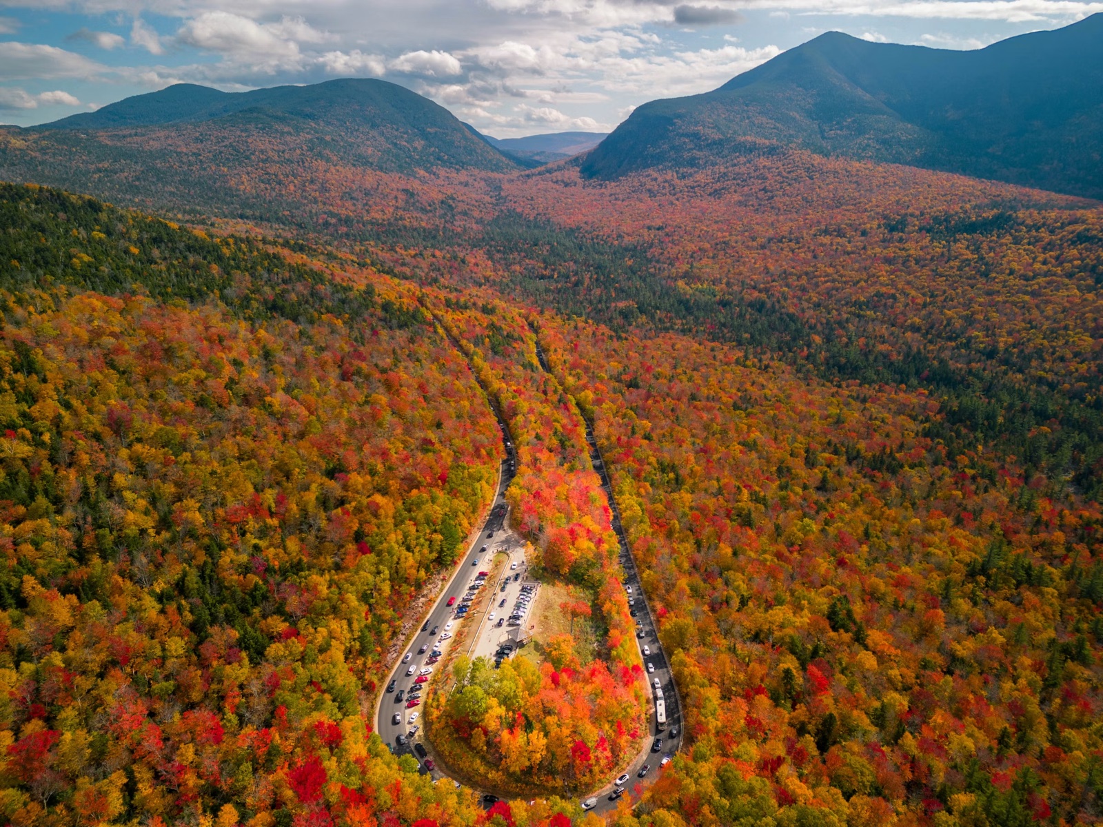 Country road winding through New England autumn foliage